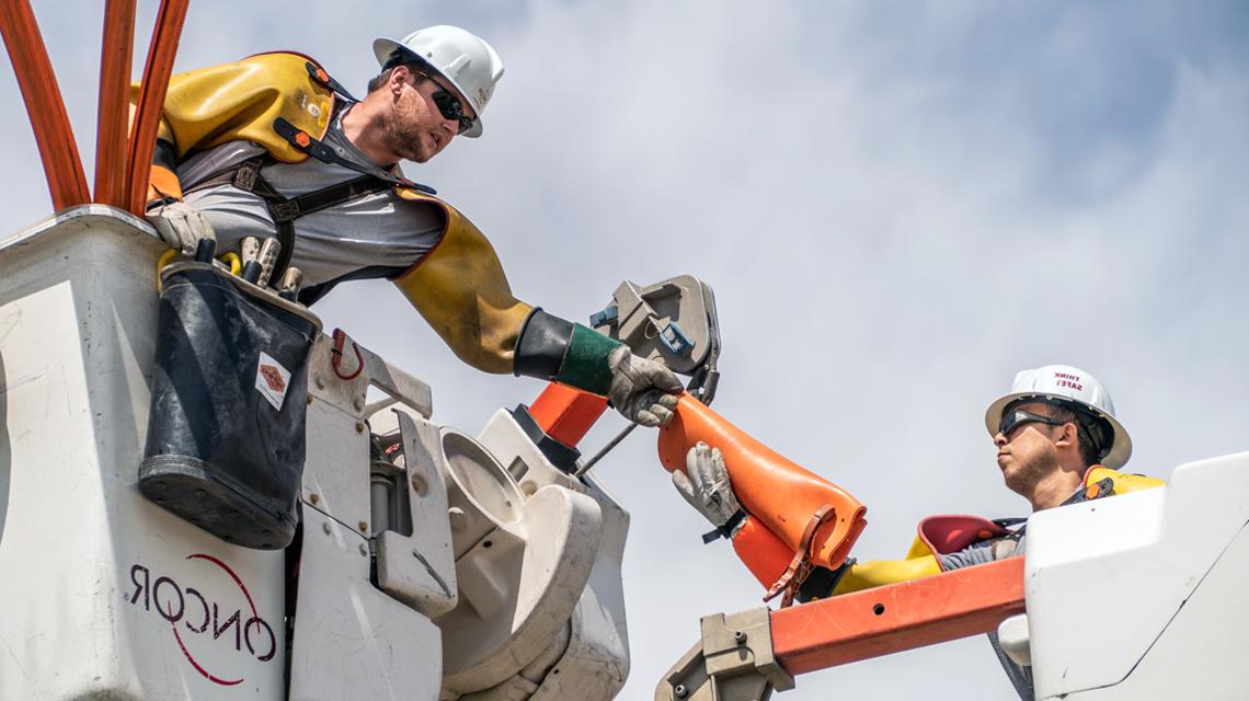 Oncor team members working on a transmission line